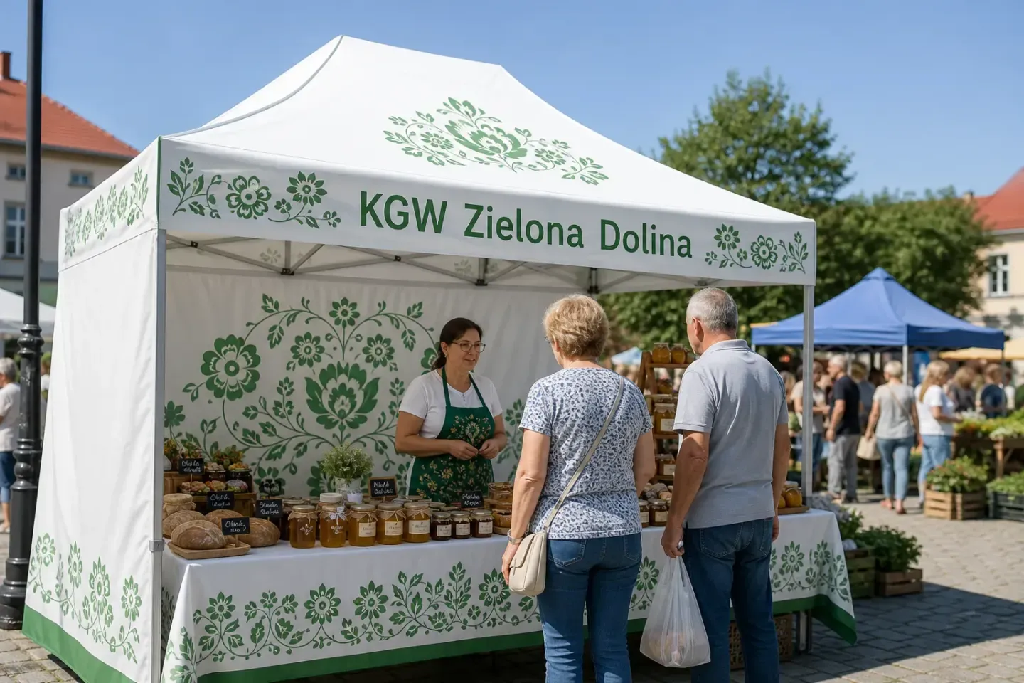 Wizualizacja: namiot ekspresowy 3 × 3 m z ludowym wzorem i nazwą koła KGW na jarmarku z miodem i przetworami